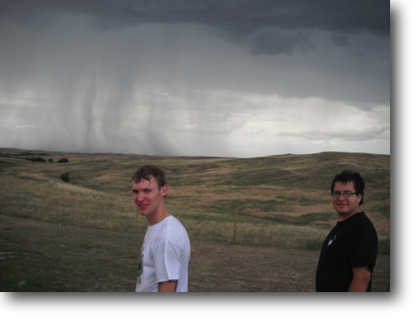 Corey and Luis on a hot summer afternoon with a fast moving rain shower to the northwest.