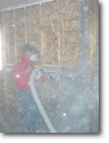 Blowing insulation into the walls.
