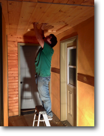 Corey working on an attic access door in the library.