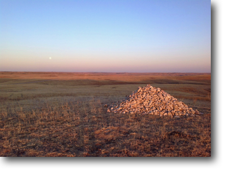 An early morning view of the cairn and the sit-ing moon.