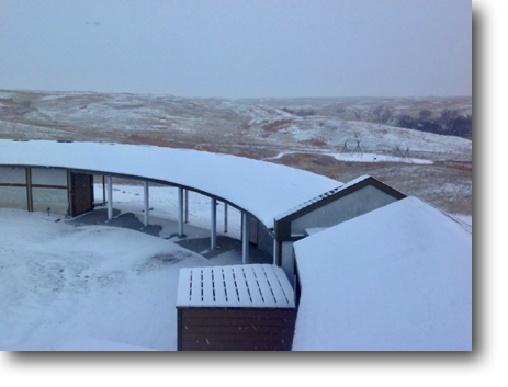 Snow covering the lower deck and curving south roof.