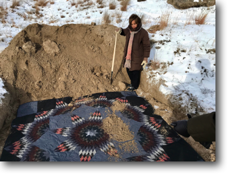 Francie burying the quilt she and Andrea sewed for the Takuwe exhibit.