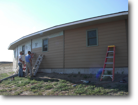 Dan and his cousin helped finish siding the north walls of the garage one hot morning.