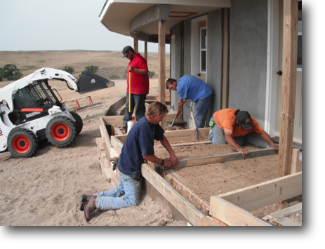 Harlan and Travis are screening the gravel for the "sidewalk" in front of the bathhouse.