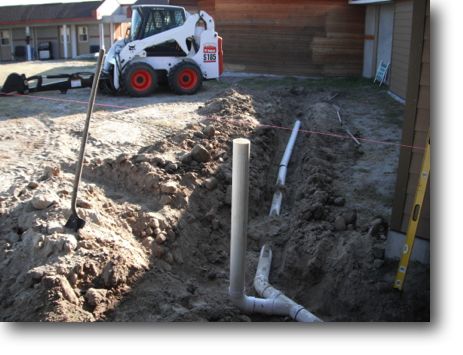 Used a backhoe attachment to trench in a drain in front of the library.