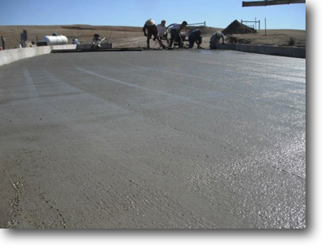 Looking east across the wet concrete at the crack concrete crew.