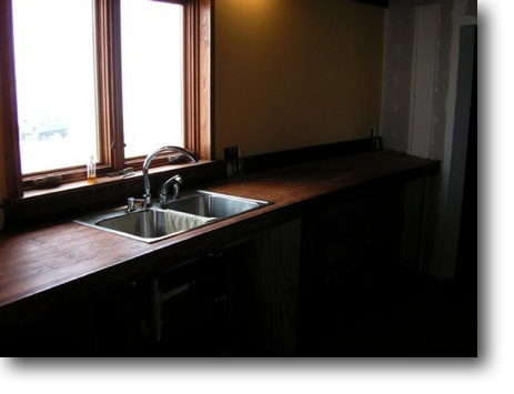 Kitchen counter stained and sink installed.
