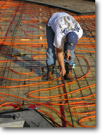 Tying the tubing to the wire mesh on top of the insulation.